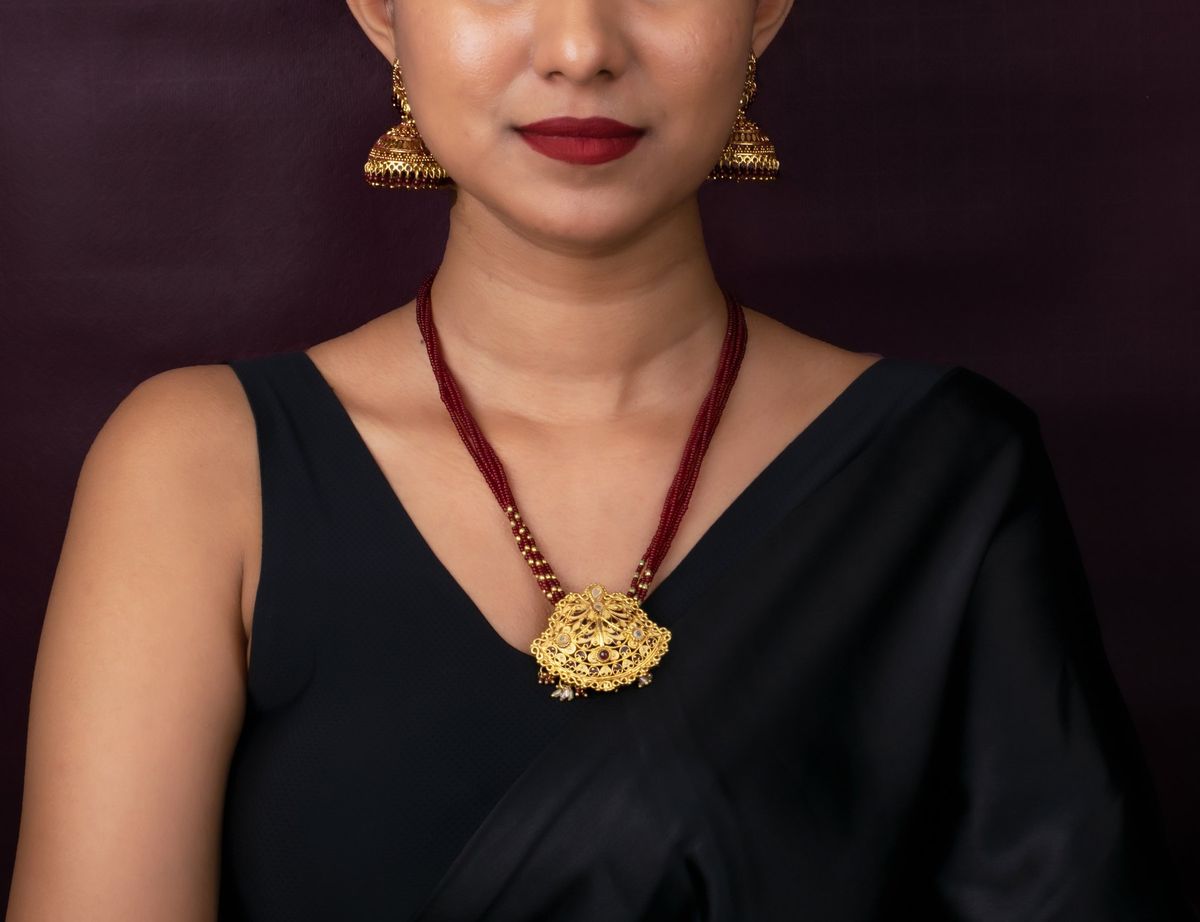 Gold pendant product photography by Team TSB